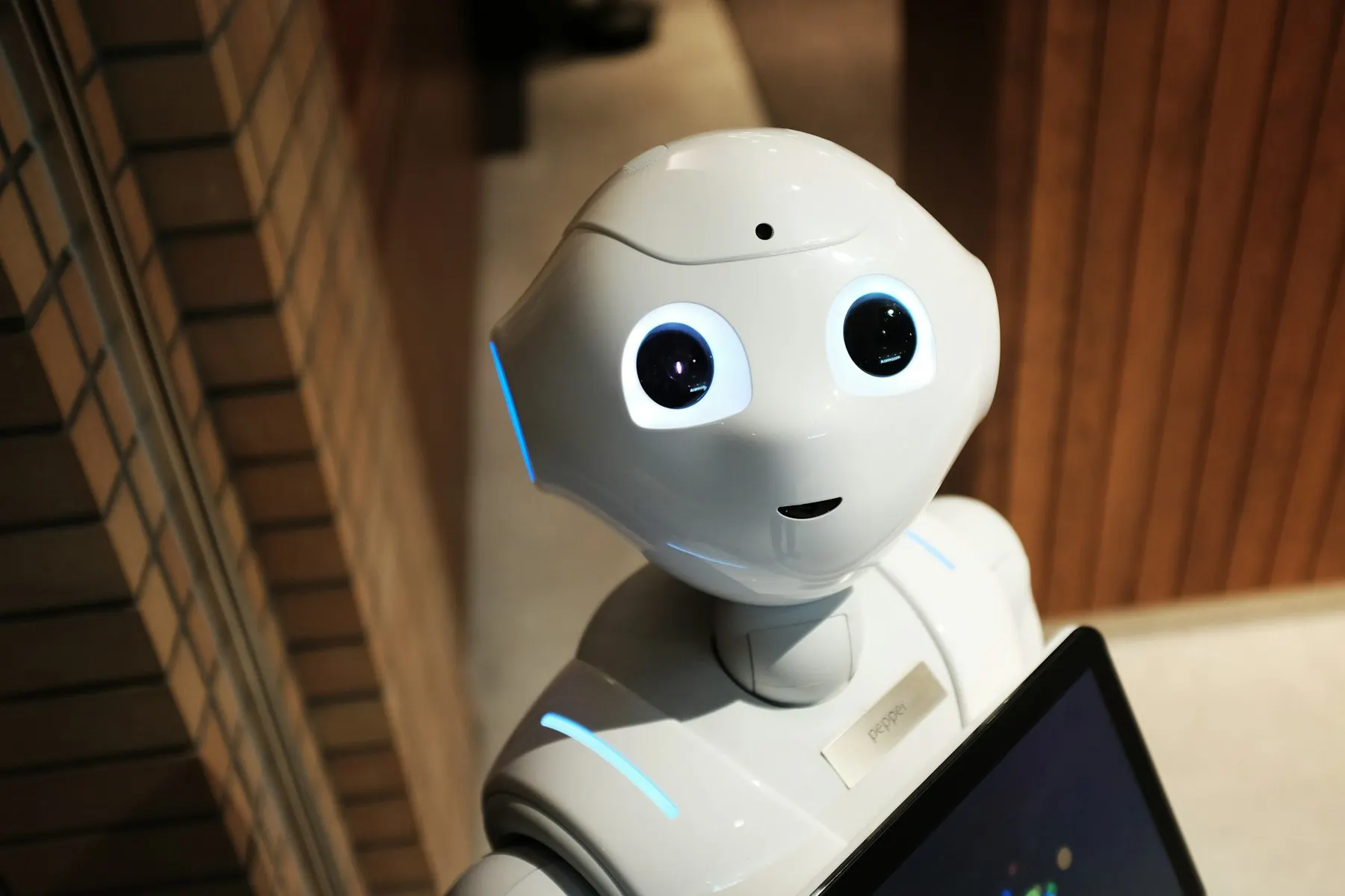 White humanoid robot with a tablet